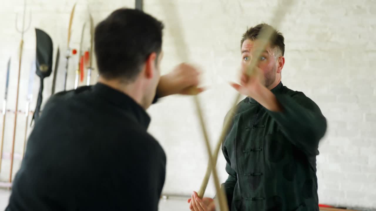 Kung fu fighters practicing martial arts with whip stick 4k