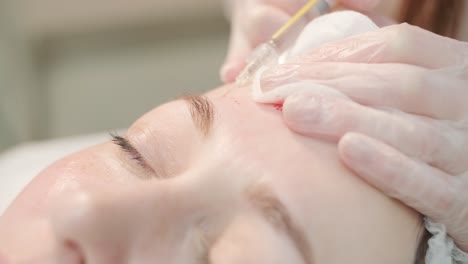 cosmetologist performing facial injection procedure