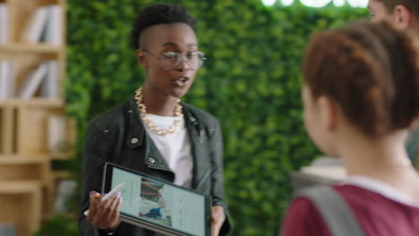 young group of business people meeting african american team leader woman using digital tablet computer sharing ideas showing training project on screen in multi ethnic office