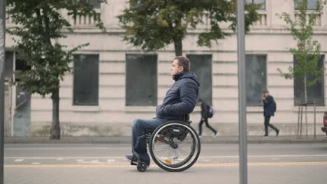 person with a physical disability waiting for city transport with an accessible ramp