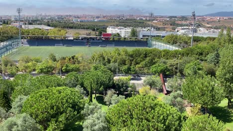 aerial-shot-of-the-Municipal-Stadium-Mário-Wilson,-Poetas-Park-and-the-city-of-Oeiras,-Portugal