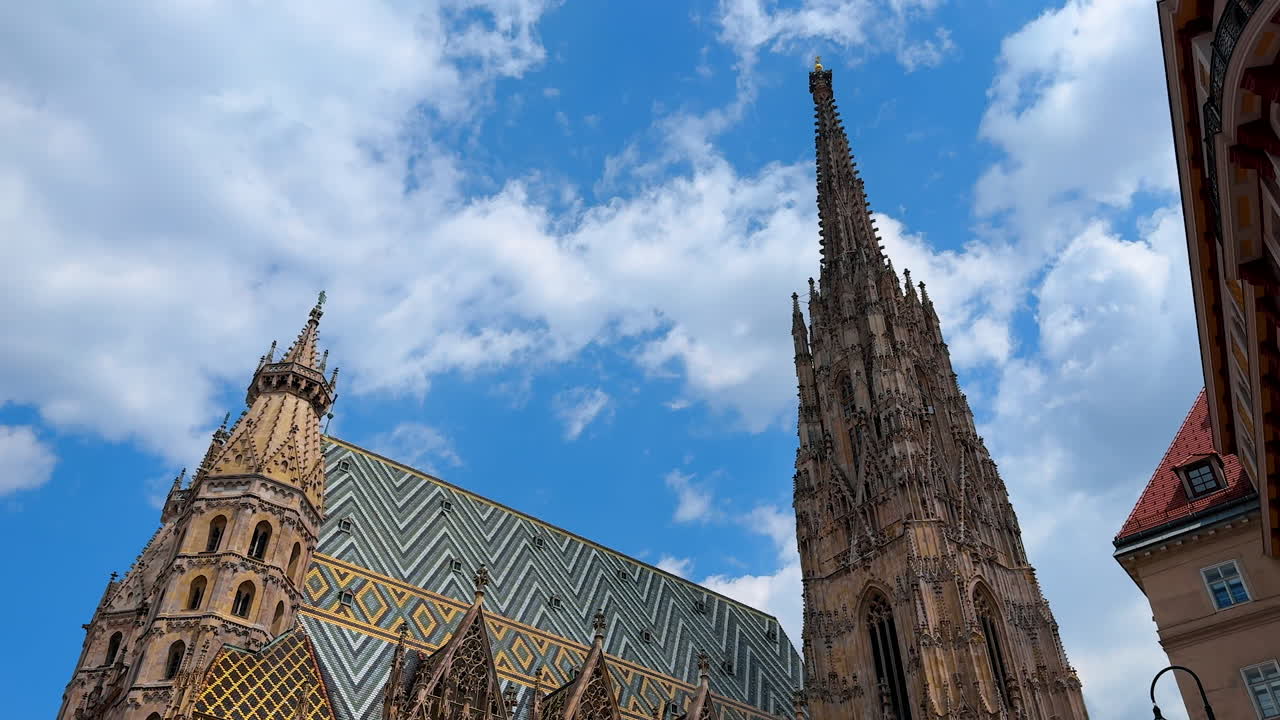 Vienna, Austria - June 9, 2025: Discover Wien's stunning architecture. Tourists admire the impressive spires and ornate details of historic buildings in Wien during a sunny day