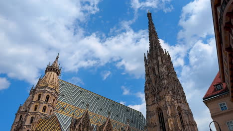 vienna, austria - june 9, 2025: discover wien's stunning architecture. tourists admire the impressive spires and ornate details of historic buildings in wien during a sunny day