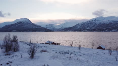 red-houses-in-norway-at-the-fjords-in-winter-on-a-cloudy-day