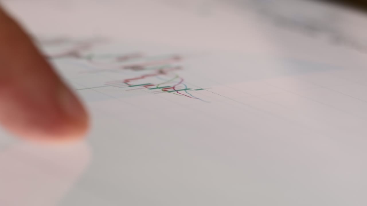 Man checks graph of stock market trading using tablet macro