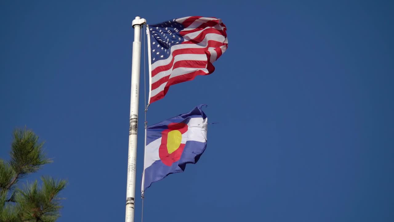 American and Colorado flags waving in slow motion