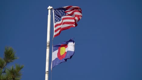 american and colorado flags waving in slow motion