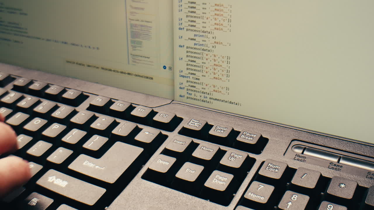 Close-Up of Hand Typing Code on Computer Keyboard