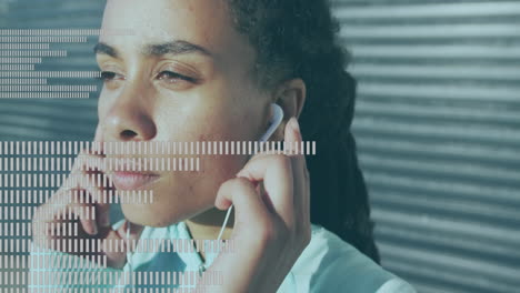 music equalizer against close up of african american woman wearing earphones