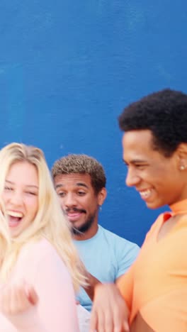 two friends dancing next to multi-ethnic friends outdoors