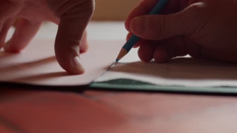marking fabric with a blue crayon close up and slow motion.