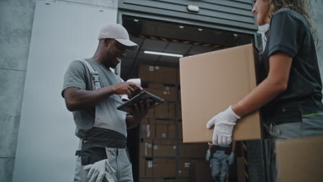 warehouse workers scanning and moving packages for logistics