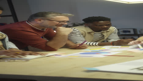 team discussing project in office at night