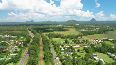 rural train through queensland small country town with picturesque mountain scenery, 4k drone australia