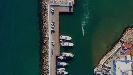 Drone-shot-rising-over-the-entrance-of-a-marina-in-Spain