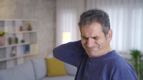 Mature-man-with-stiff-neck-rubbing-his-neck.