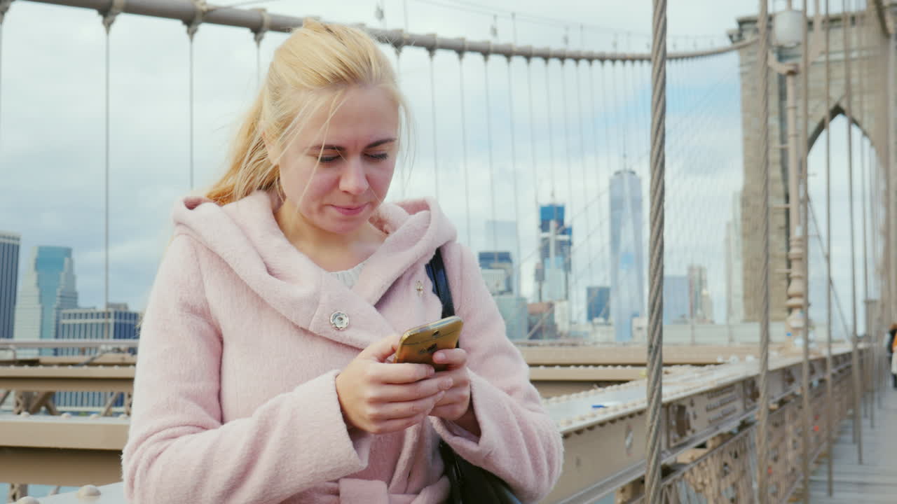A Young Woman Uses A Smartphone 2