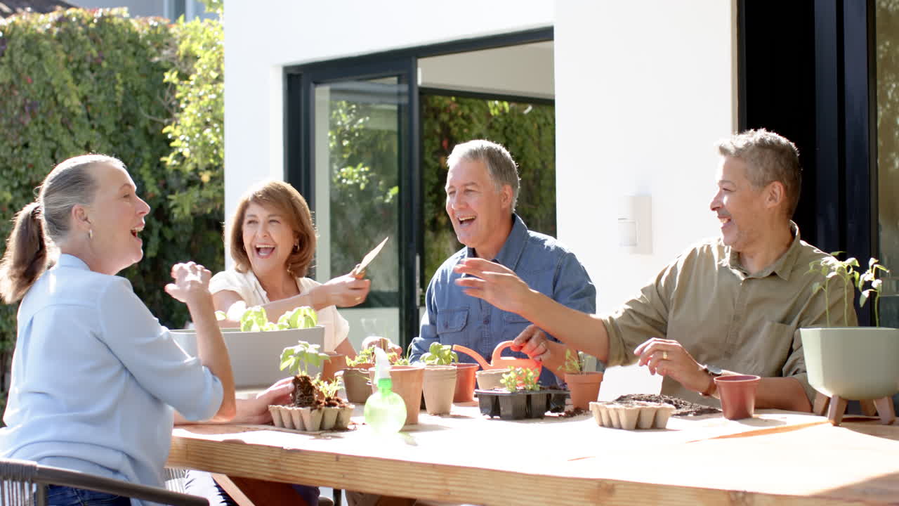 Gardening together, senior friends planting seedlings and sharing tools outdoors