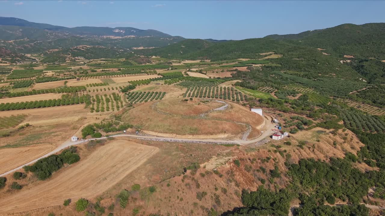 Drone footage revealing the famous Amphipolis Tomb (Kasta) and its surroundings. Majestic aerial view of historic and archaeological site in Greece