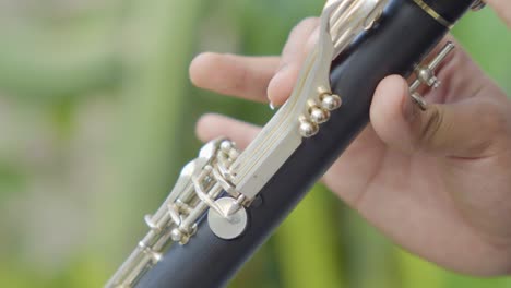 a close-up shot of how a young performer is playing on a clarinet