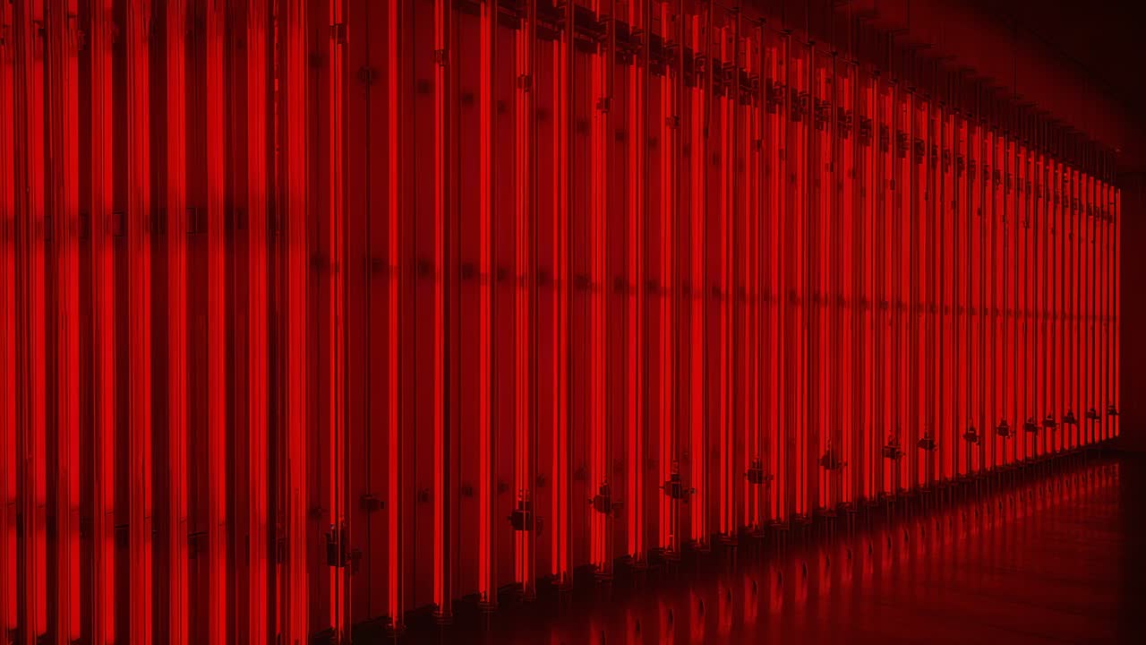 Moving camera revealing long vertical red light tubes in gallery corridor to highlight reflections