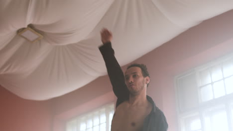 young man dancing in a classroom