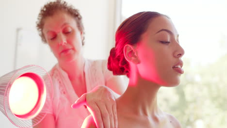 female chiropractor giving advice while using heat