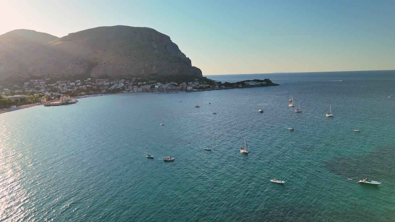 Serene coastal view with boats in calm blue sea under clear sky