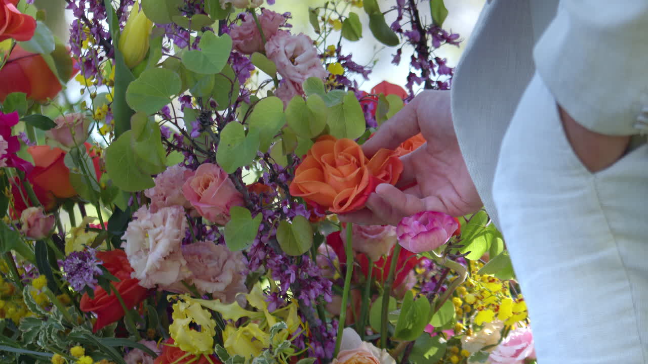 Beautiful Mixed Flowers Decor Touched By A Groom In A White Suit. Slow Motion Shot