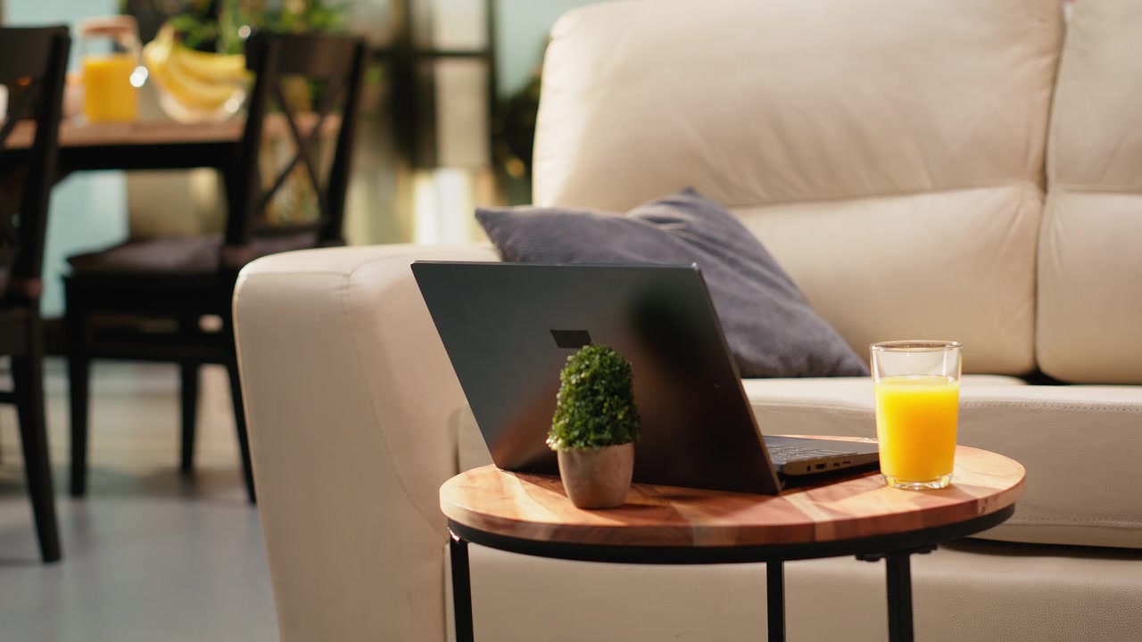 Empty coffee table with orange juice glass in living room space