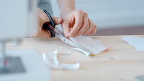 woman sewing a mask or other garment