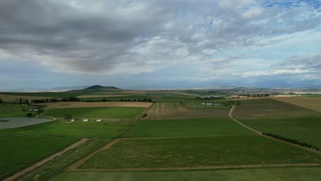 Green-valley-at-Cape-Winelands-in-South-Africa-on-cloudy-day,-aerial