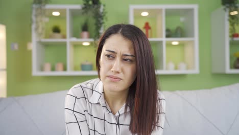 frustrated young woman looking at camera.