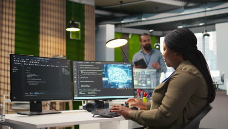female technician using computer to write code, developing machine learning api
