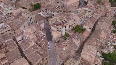 Reveal-shot-of-Fornalutx-mountain-village-main-street,-aerial