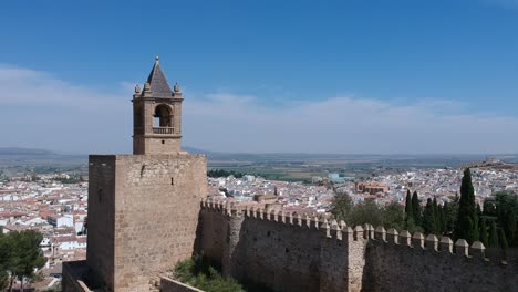 Flying-over-a-Moorish-castle-in-a-town-in-Malaga,-Andalusia