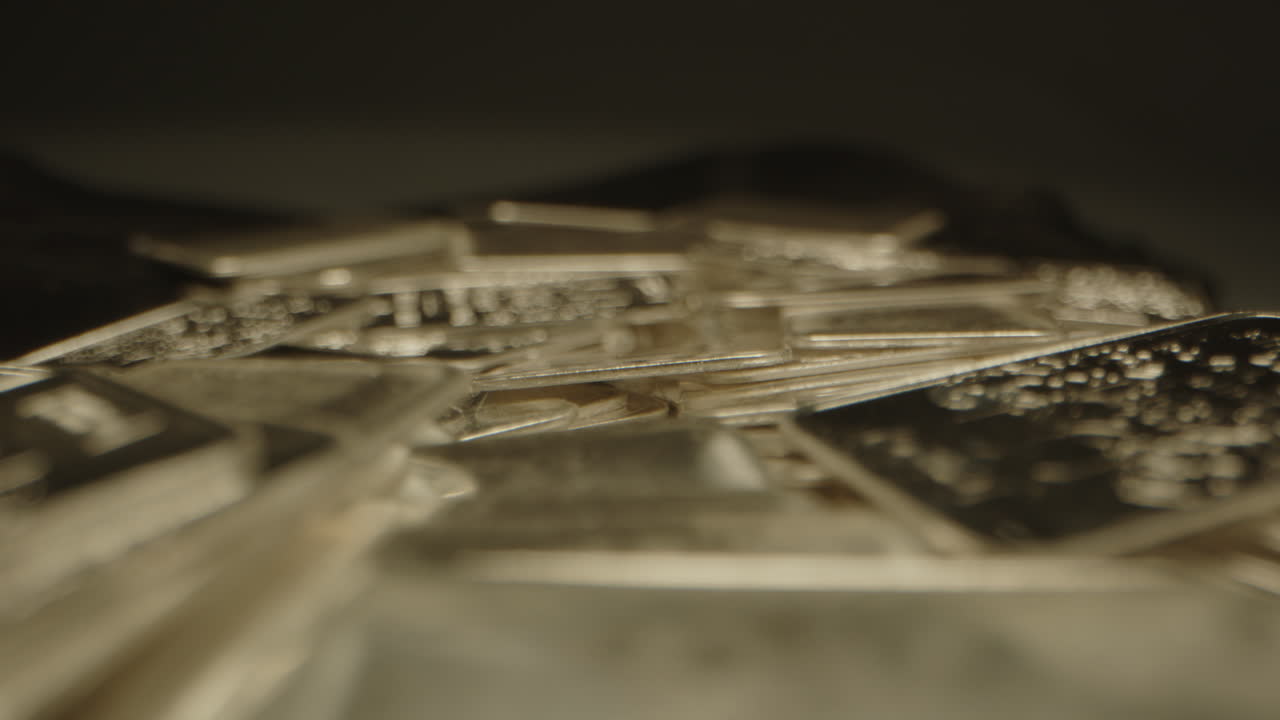 Macro focus rack of detailed shiny silver plates on a velvet surface in a well lit studio