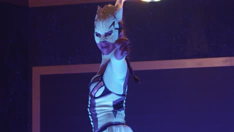 tracking shot of woman in costume showing dance performance with lighting hula hoop.