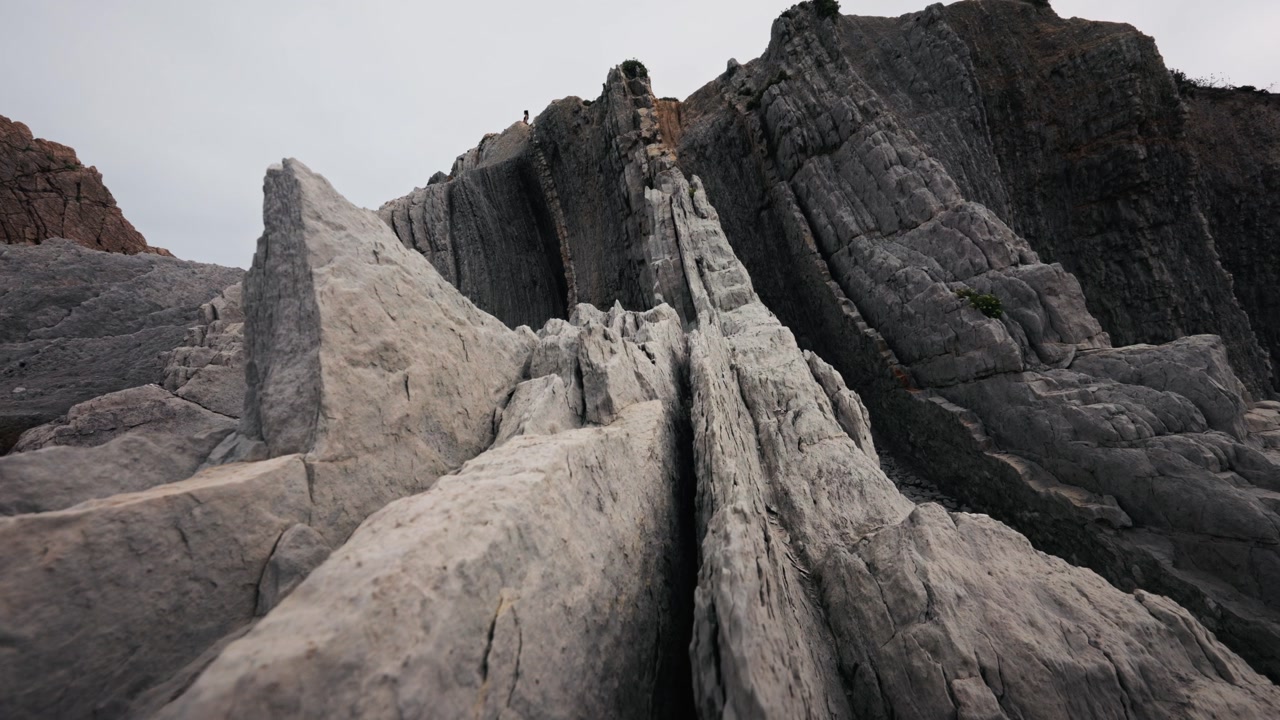 Low angle panning shot of flysch rock formations at La Arnia coast Cantabria Spain