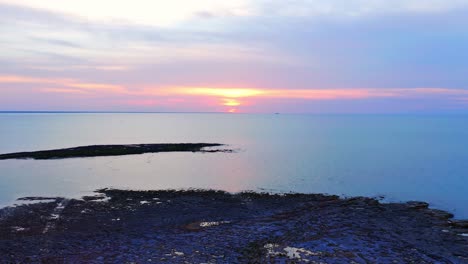 golden sunset at the coastline of nightcliff suburb in the city of darwin, northern territory, australia