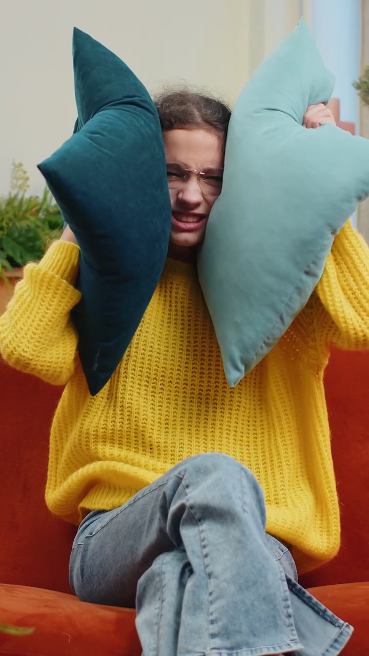 Neighbors repair work irritated girl by loud music at home cover ears with pillows annoyed by noise