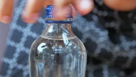 person opening a bottle of water