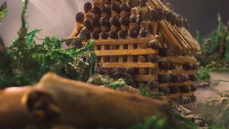 staged-scene-with-old-stubs-near-house-of-matches-in-smoke