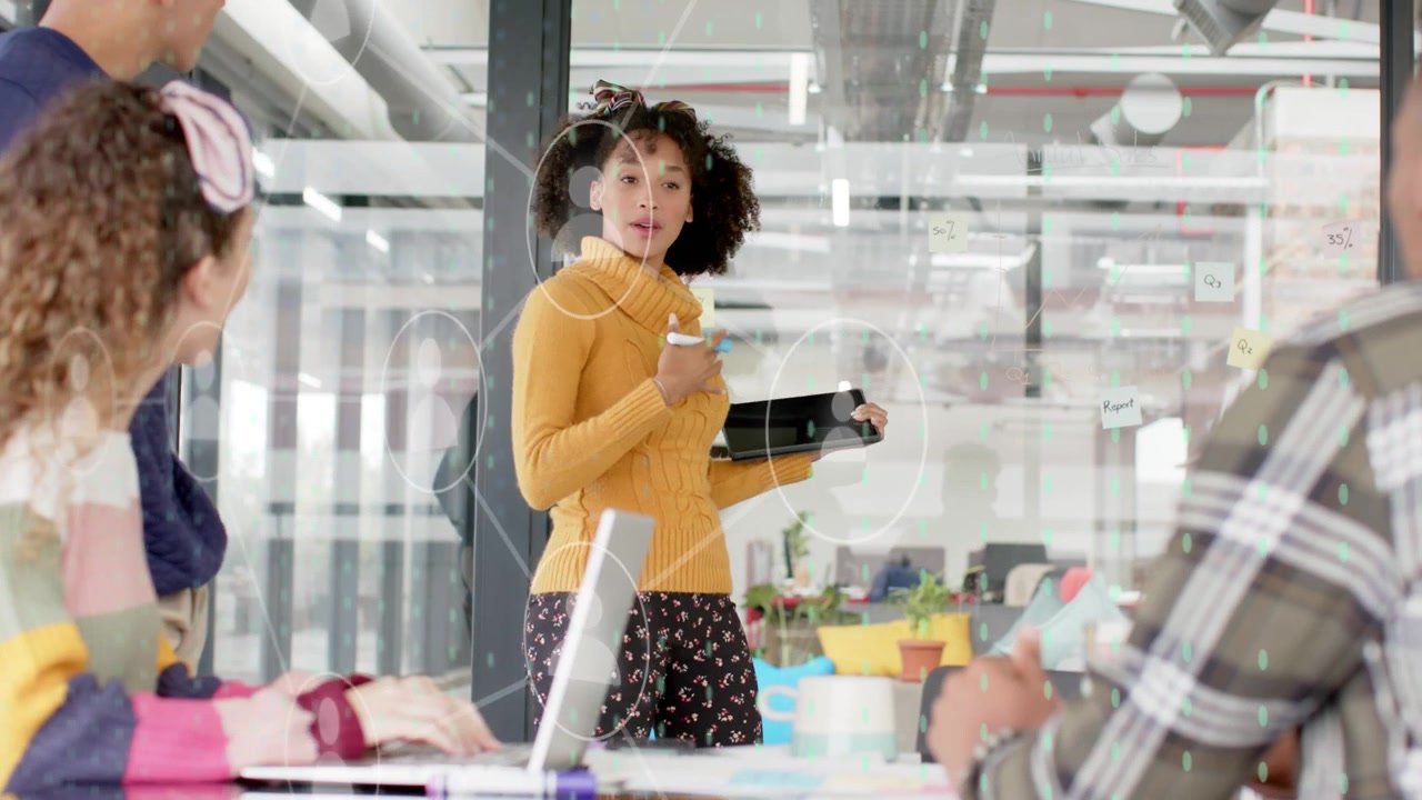 Presenter entering business meeting, tapping tablet and activating circular UI while guiding team