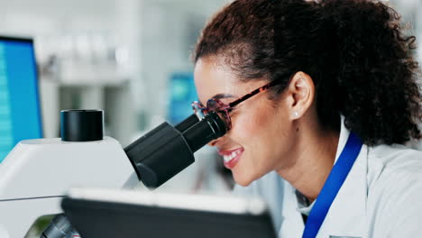 scientist examining samples under a microscope in a laboratory