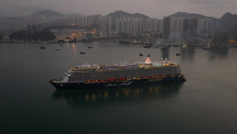 smoke coming from the funnel of a luxury cruise ship arrivingin hong kong