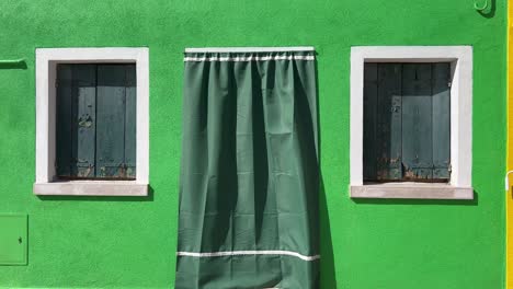 Explore-Burano-Island,-Venice:-4K-Static-Shot-of-a-Distinct-Light-Green-House