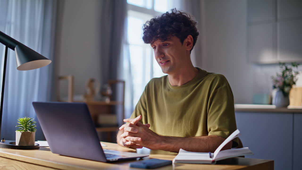 Smiling man speaking laptop video call home closeup. Freelancer computer webchat