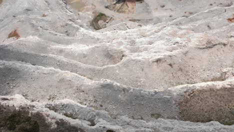 Drone-slow-flight-top-down-view-quarry-steps-industry-sunny-day