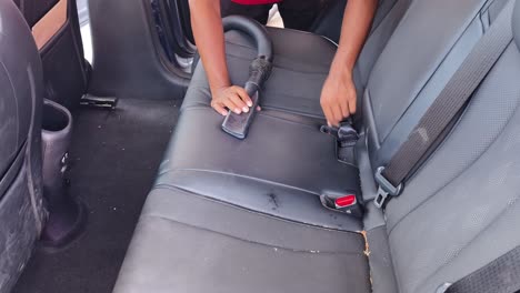 vacuuming a car back seat
